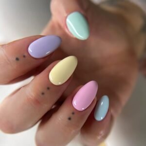 pastel multi colored oval nails in purple yellow pink and blue with finger tattoos