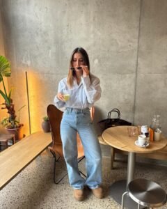 woman in blue striped button down shirt and light wash baggy jeans