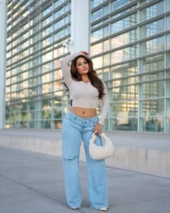 woman wearing wide-leg jeans and crop top