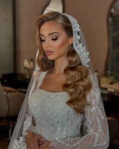 bride with long blonde Hollywood waves wearing a lace veil and beaded gown