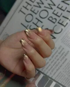 square nails with gold cat eye ombre and metallic chrome tips.