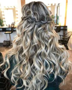 blonde wavy hair with a horizontal waterfall braid and curled ends