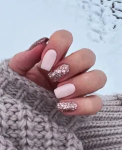 square light pink manicure with rose gold glitter accent nails and knit sweater.