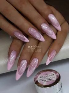long pointed pink nails with shimmering rose quartz cat eye french tips.