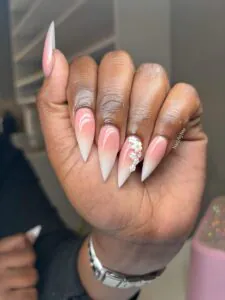 long ombre stiletto nails in pink and white with delicate white flower accents