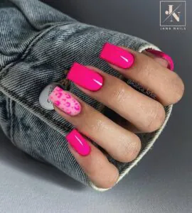 vibrant hot pink square nails with one pink leopard print accent nail.
