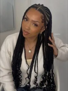 woman with long fulani braids featuring wavy ends and laid baby hairs