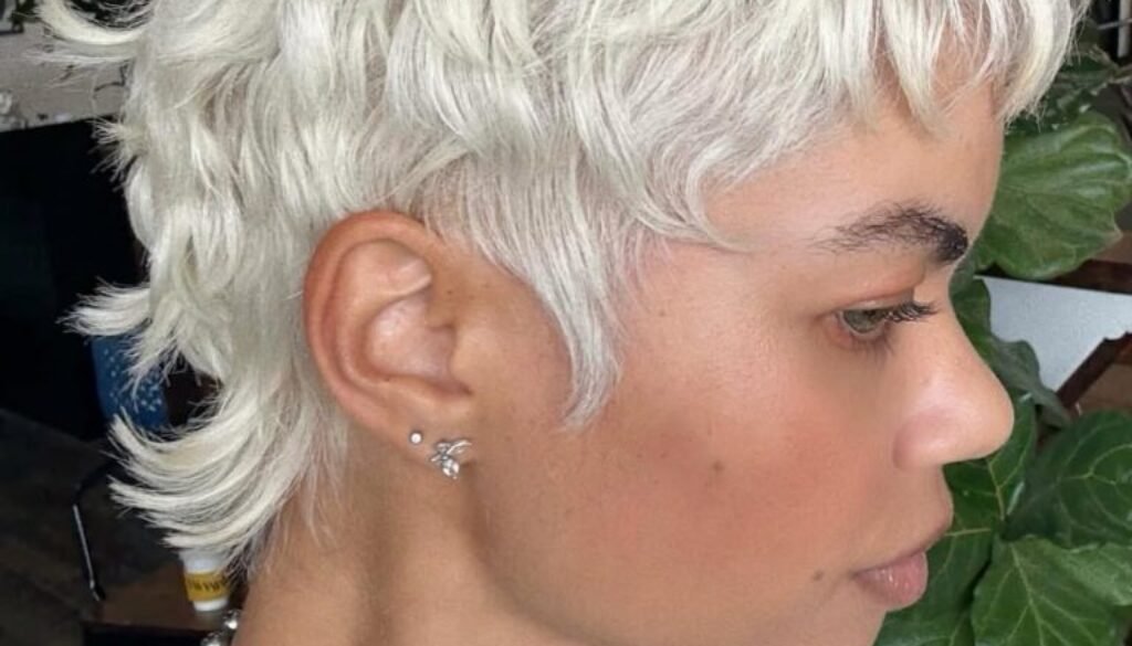 platinum blonde pixie cut with textured layers and side profile view