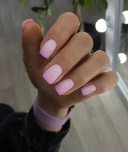 short square pink nails featuring a lavender purple french tip design and glossy finish.