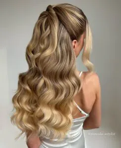 back view of long blonde wavy hair in a half up bridal style
