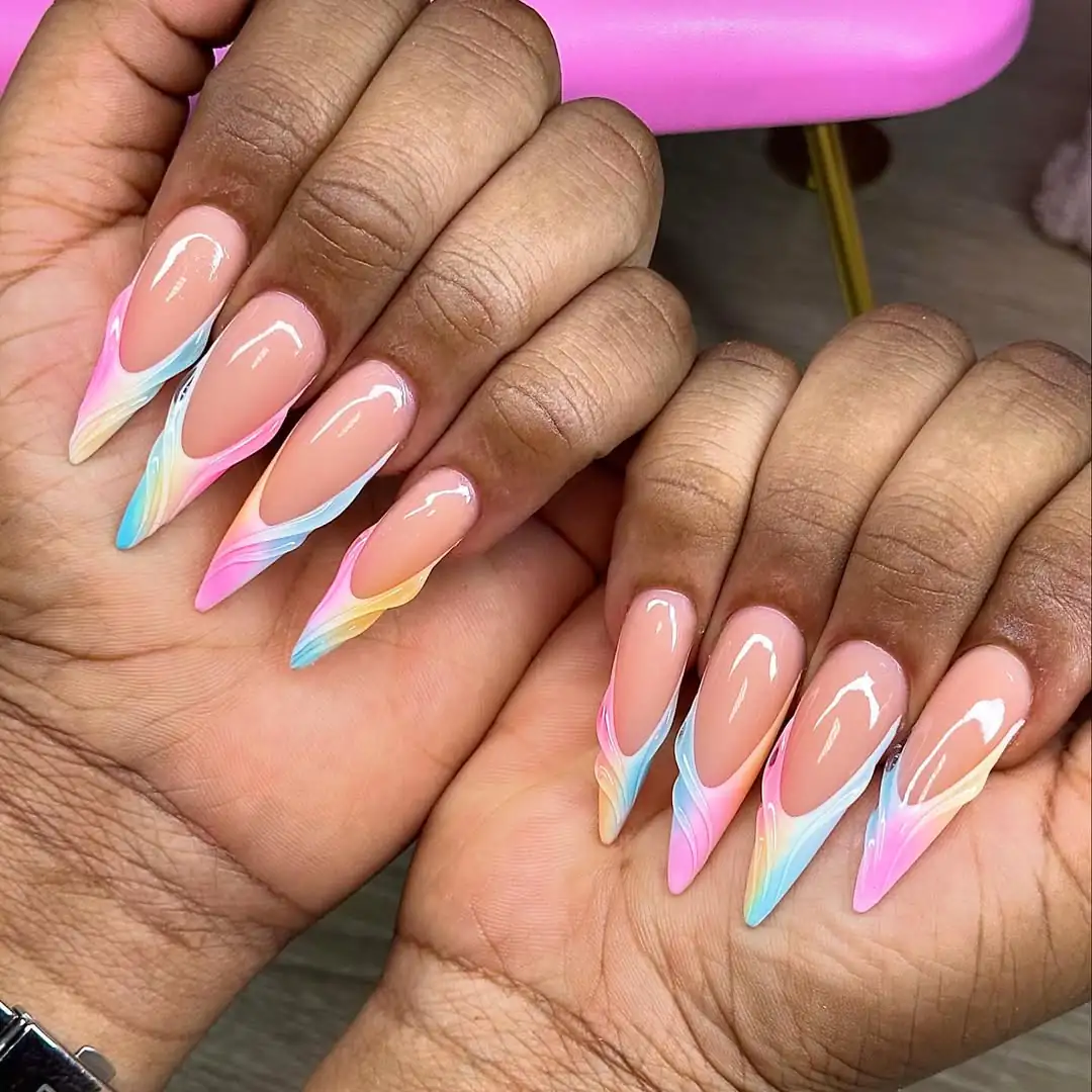 long almond nails featuring colorful pastel swirl french tips in pink, blue, and yellow.