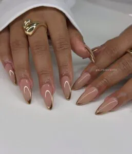 neutral stiletto nails with thin metallic bronze chrome french tips