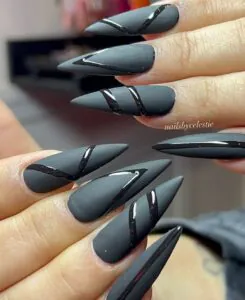 matte black stiletto nails with glossy black diagonal wave patterns
