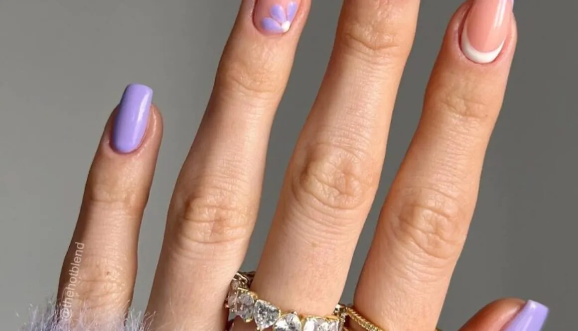 square lilac nails featuring purple floral art and French tips with gold rings