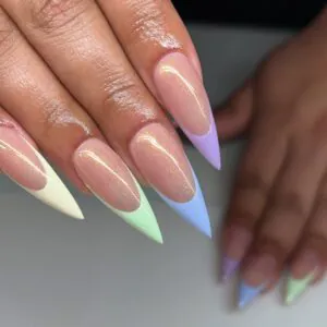 stiletto nails featuring pastel french tips in yellow green purple and blue