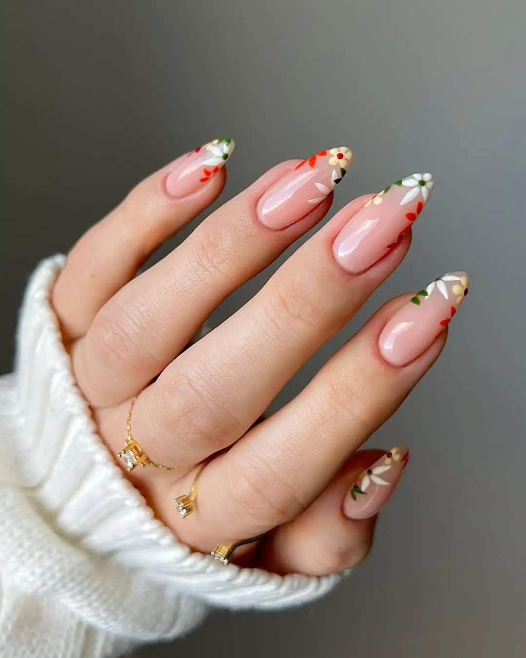 long almond nails with nude base and delicate hand painted floral nail art