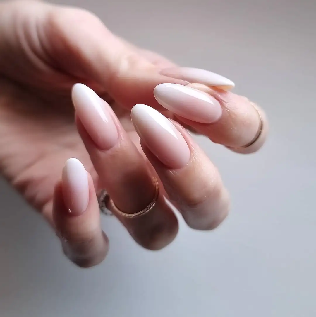 oval ombre nails fading from soft nude pink to milky white tips