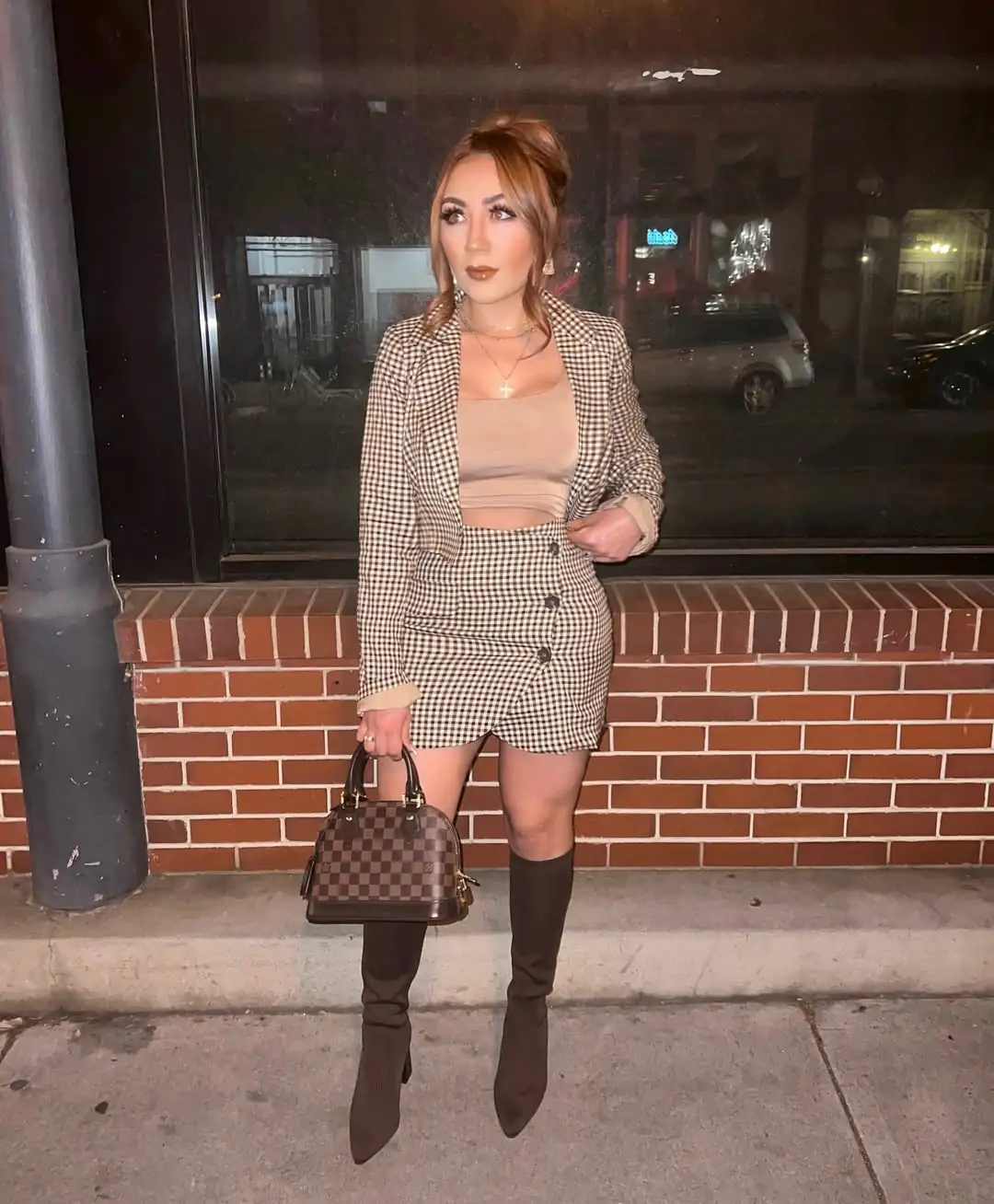 woman in plaid blazer and skirt set with dark knee high boots