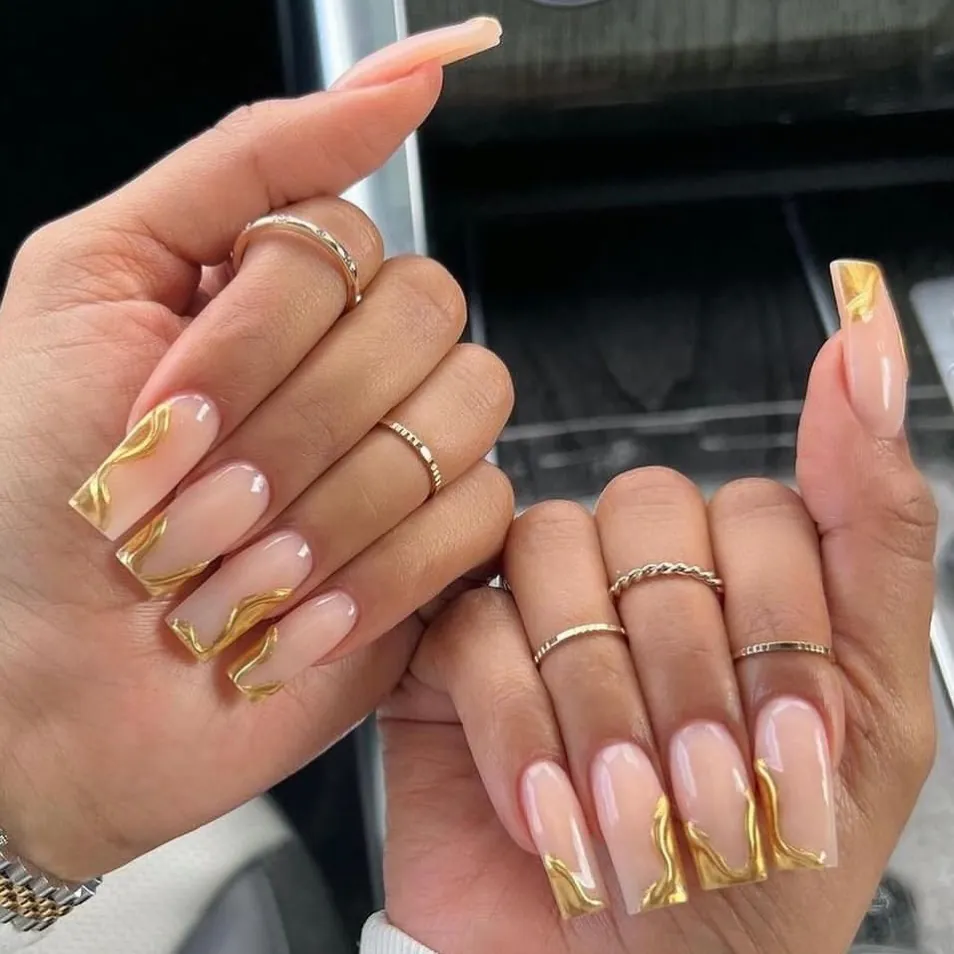 long square nude nails with gold metallic swirl nail art