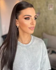 woman with sleek straight dark hair tucked behind ears and winged eyeliner