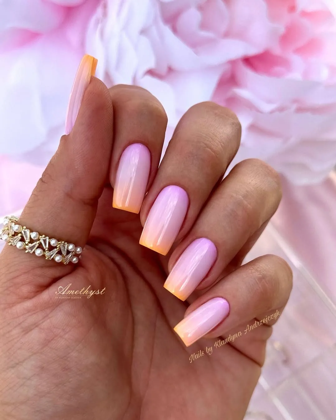 long square gel nails featuring a vibrant pink and orange sunset ombre gradient