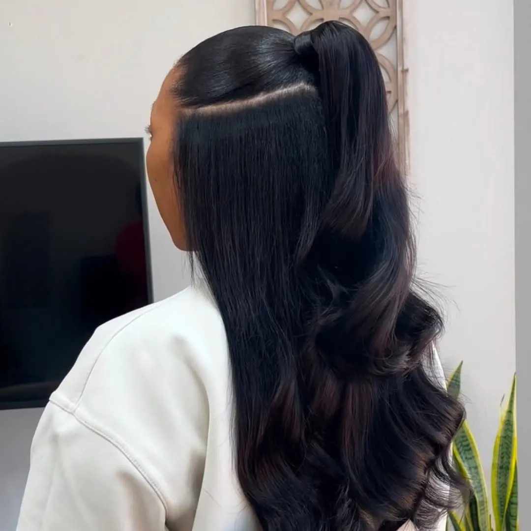 sleek black hair in a half-up high ponytail with soft bouncy curls at the ends.