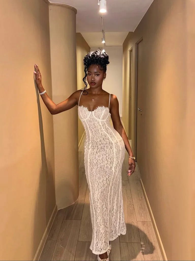 black woman in a floor-length white lace corset gown all-white party outfit