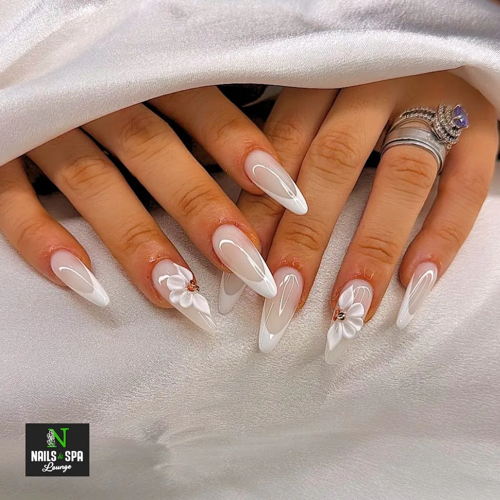 long almond nails with white french tips and 3d sculpted flower art
