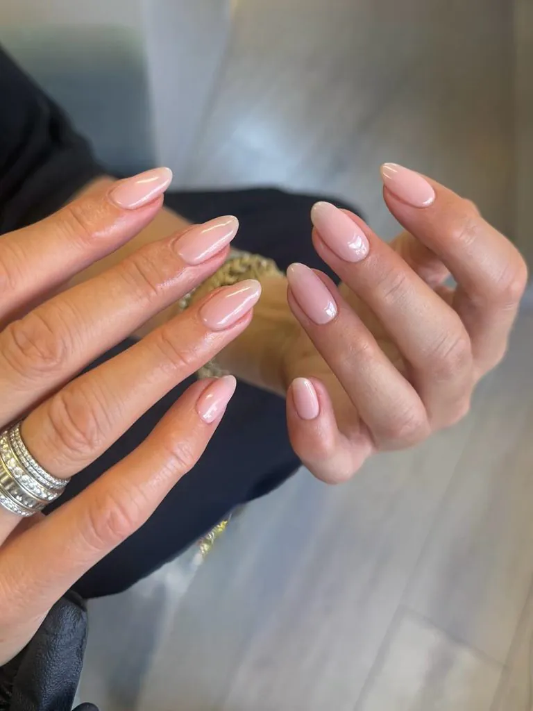 elegant short oval shaped manicured nails with a glossy nude pink polish