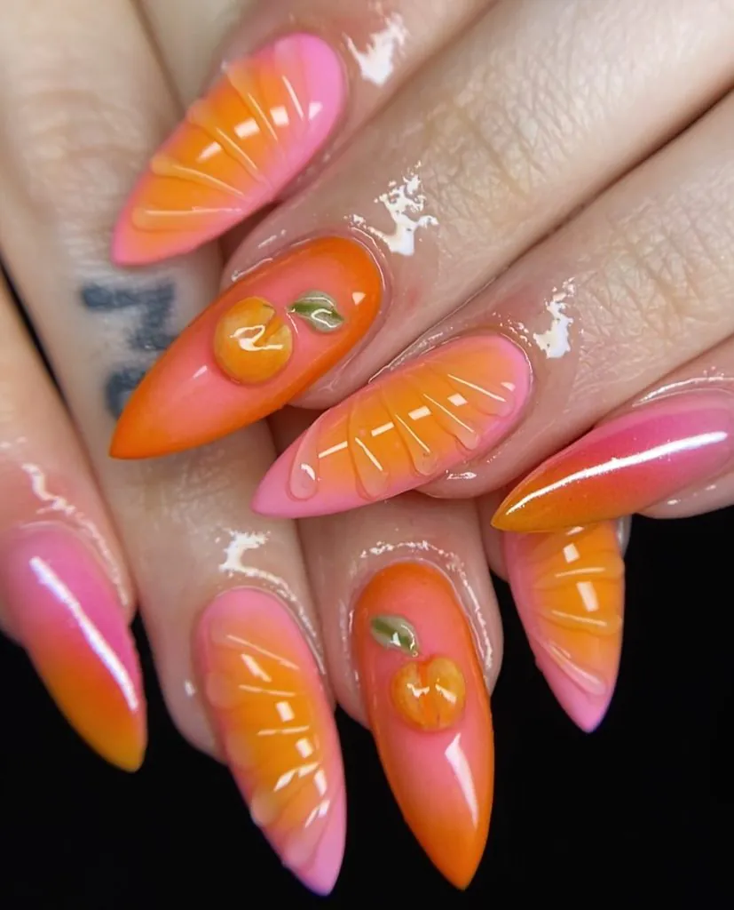 almond nails featuring 3d orange fruit slices and peach nail art designs