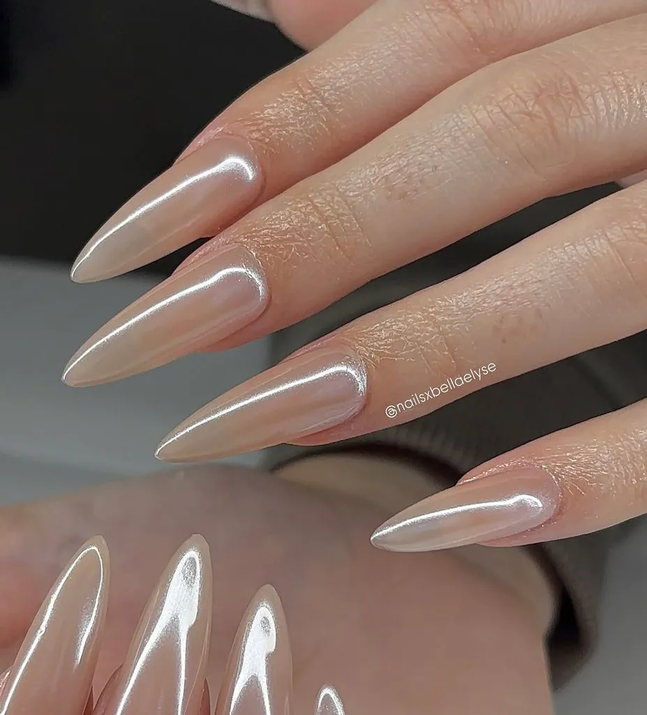 long pointed stiletto nails with a glossy metallic champagne chrome finish