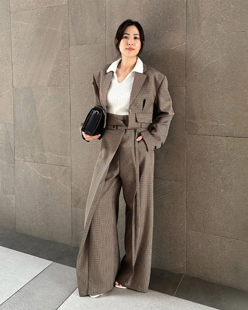 woman wearing brown checkered blazer and wide leg trousers matching set