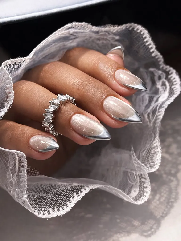 shimmering cat eye french tip nails with metallic silver pointed edges and lace detail