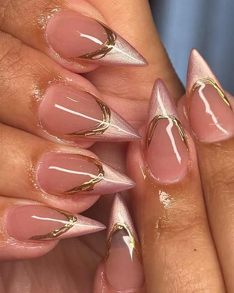 sharp stiletto cat eye french tip nails with thin metallic gold accent outlines