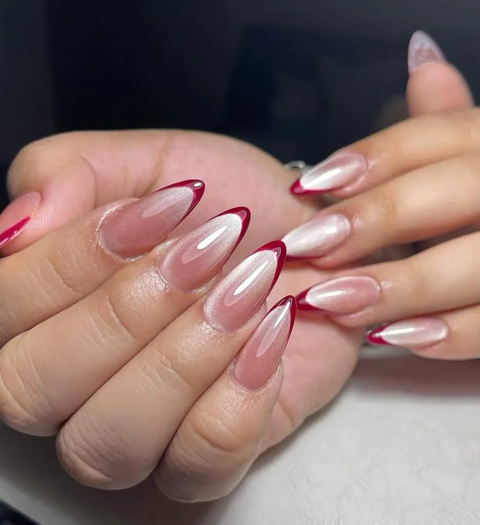 deep red French tips paired with shimmering neutral cat eye french tip nails