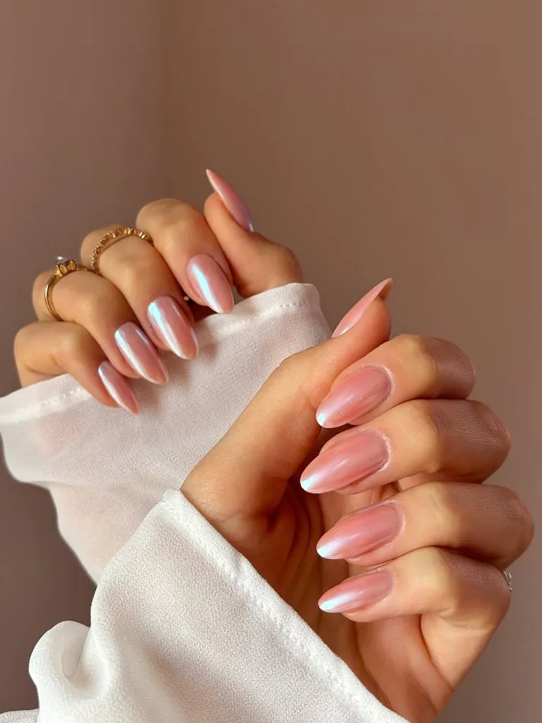 shimmering pearlescent pink glazed donut style manicure on long almond shaped nails