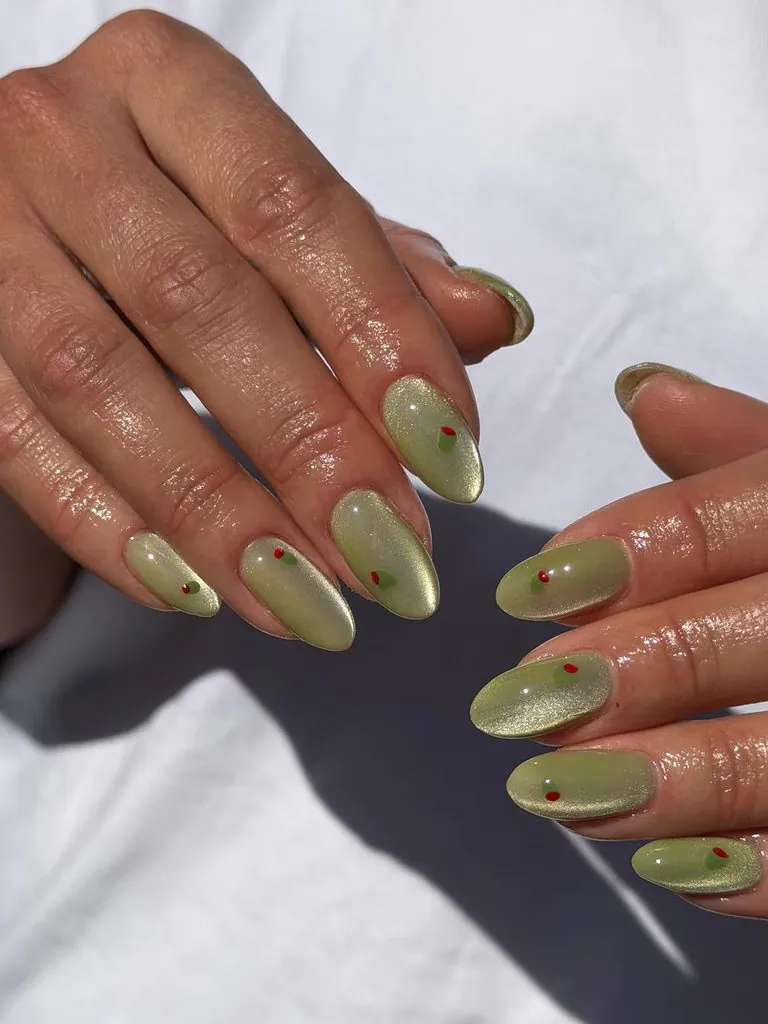 shimmering olive green cat eye magnetic manicure with mini red dot details
