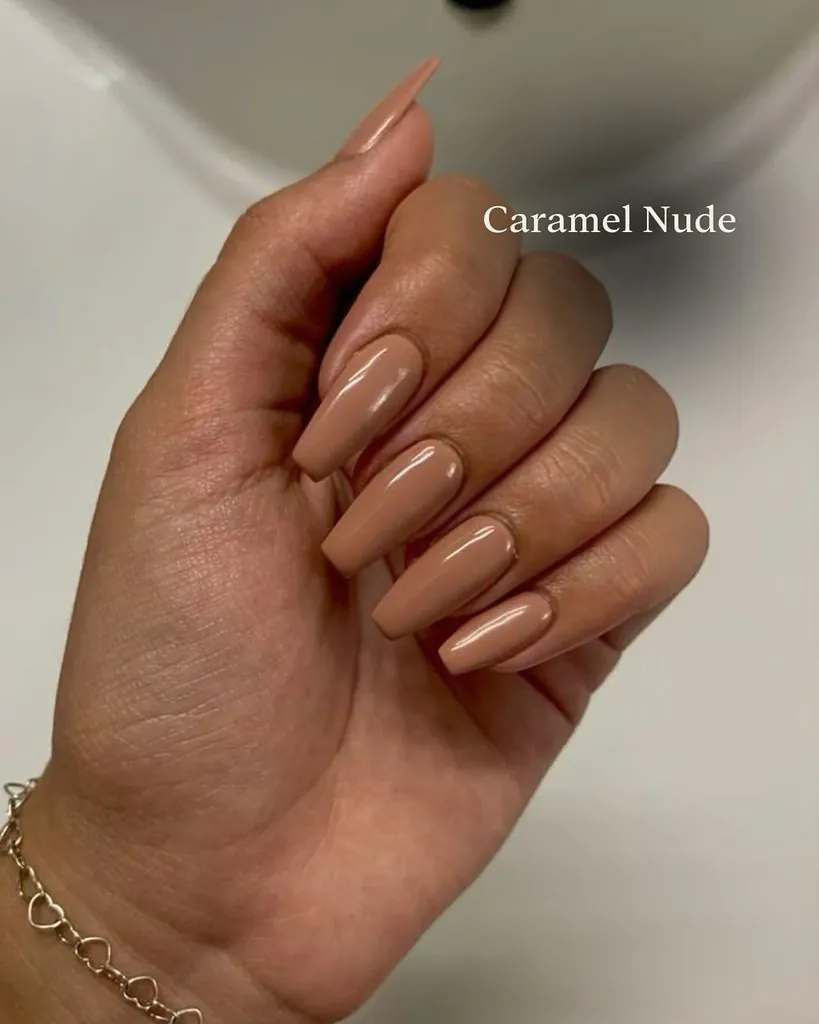 caramel nude brown color manicure on long square shaped acrylic nails