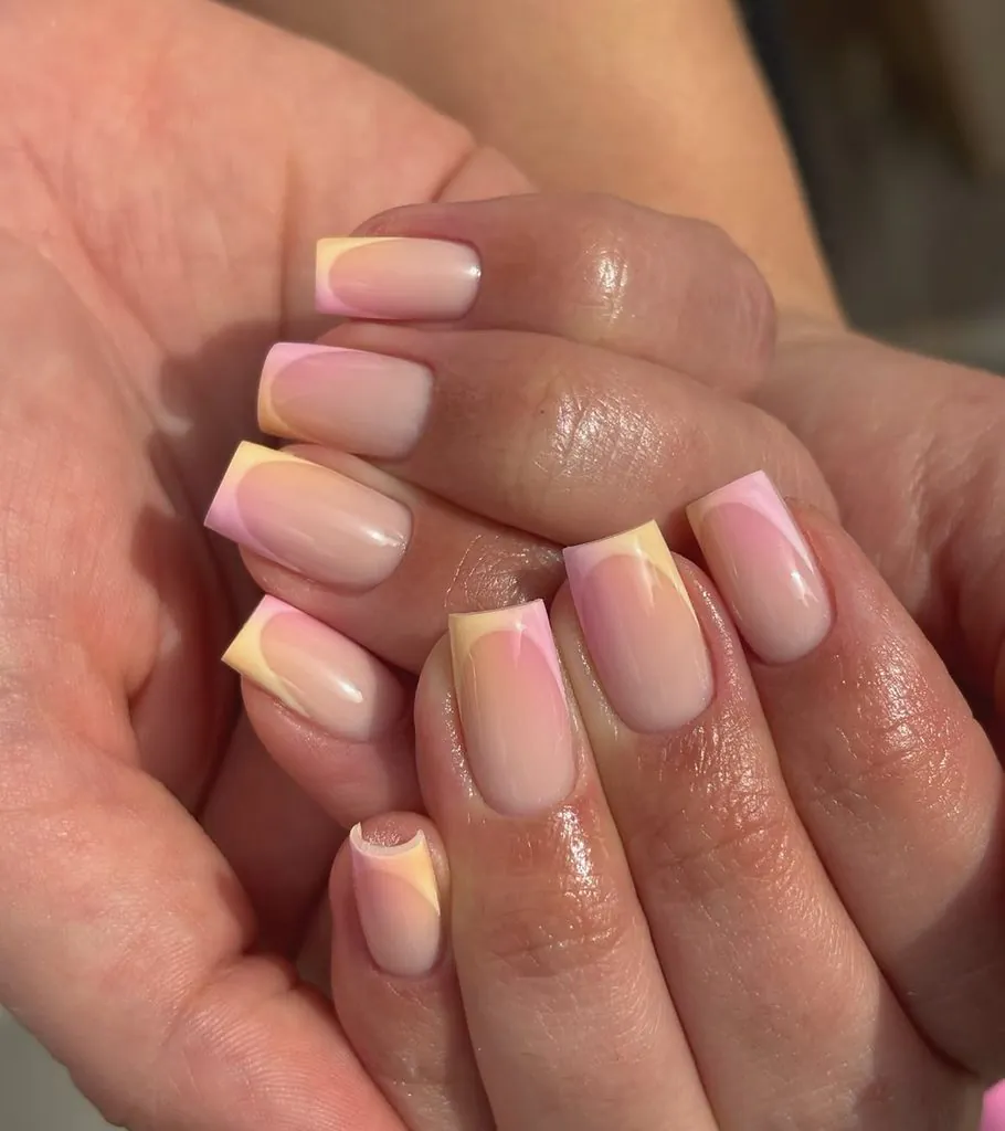 square acrylic nails with pastel yellow and pink gradient ombre french tip manicure