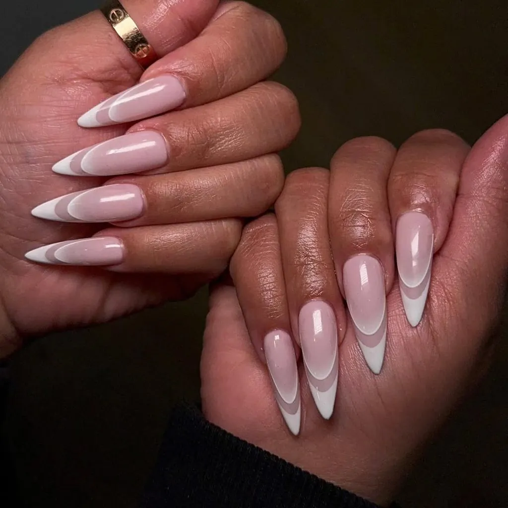 pointed stiletto nails with double white outline french tip manicure on dark skin