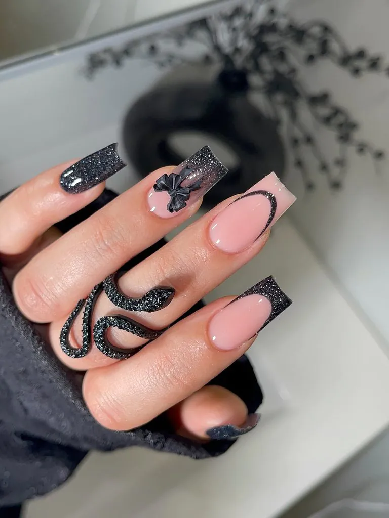 long square black french tip nails featuring glitter, bow, and snake details