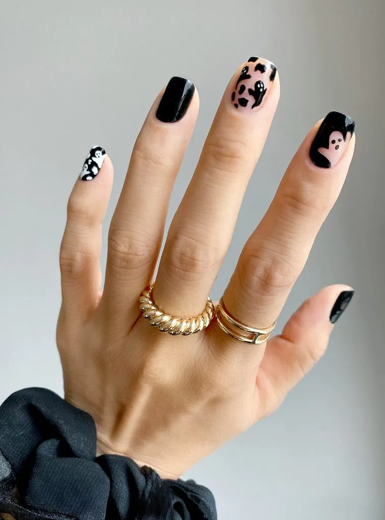 short square black nails featuring white and black ghost art designs
