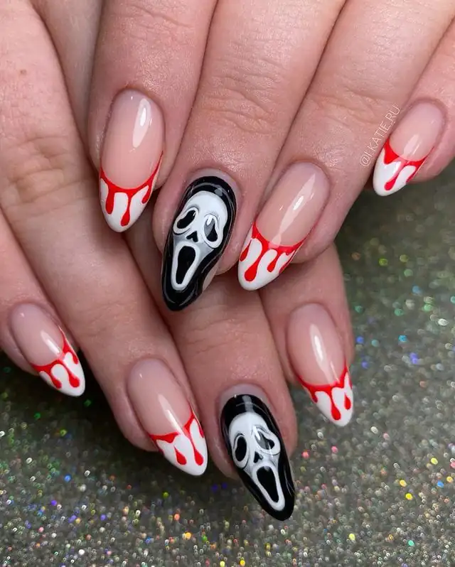 long almond nails featuring ghost face art and red dripping blood french tips