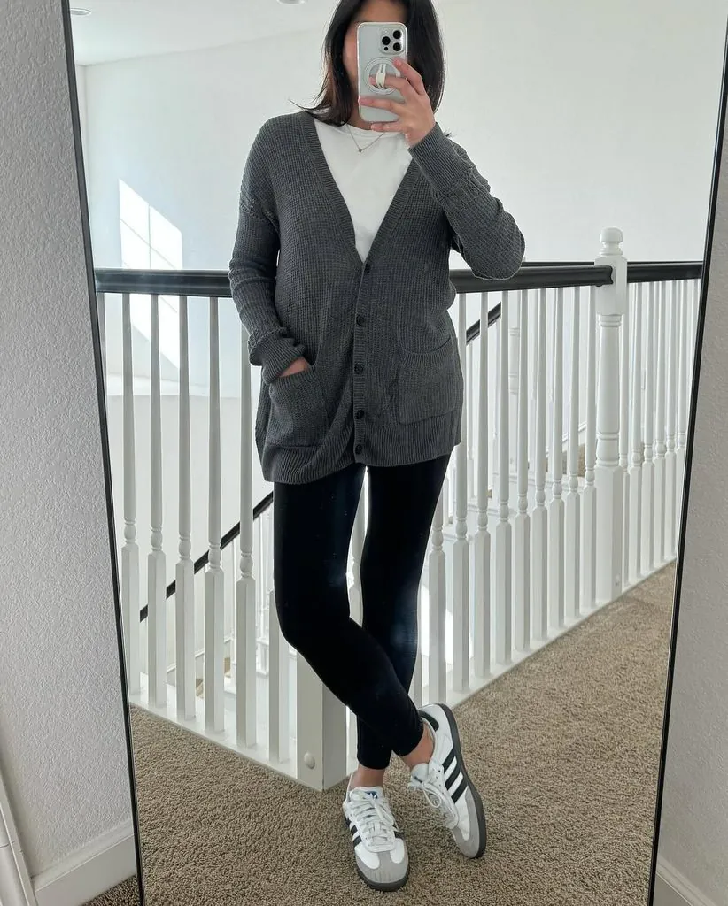 woman in black leggings, white tee, grey button-up cardigan, and white sneakers