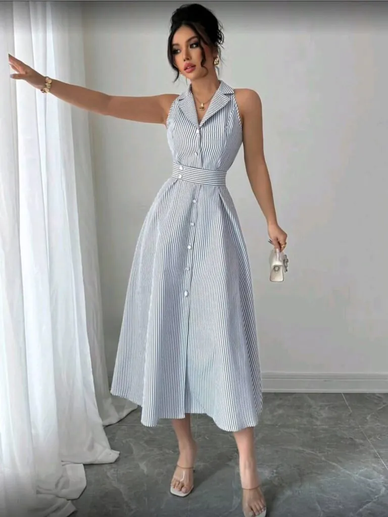woman wearing blue and white striped midi dress with heels and small handbag