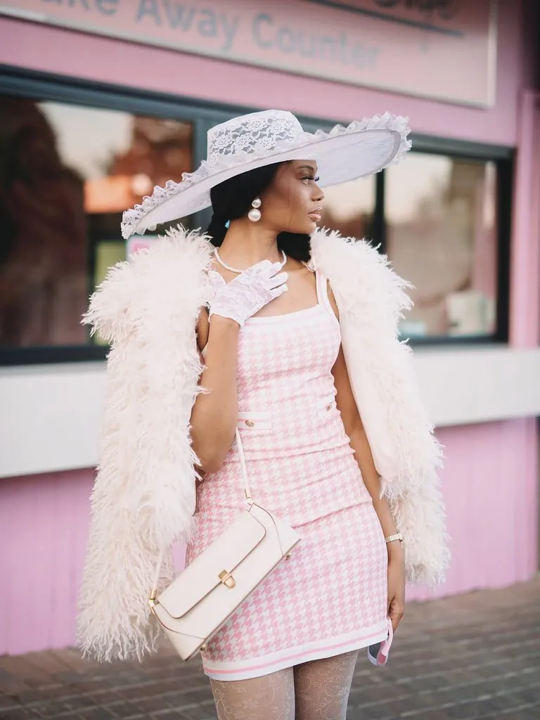 woman wearing a white lace hat and pink houndstooth dress tea party outfit