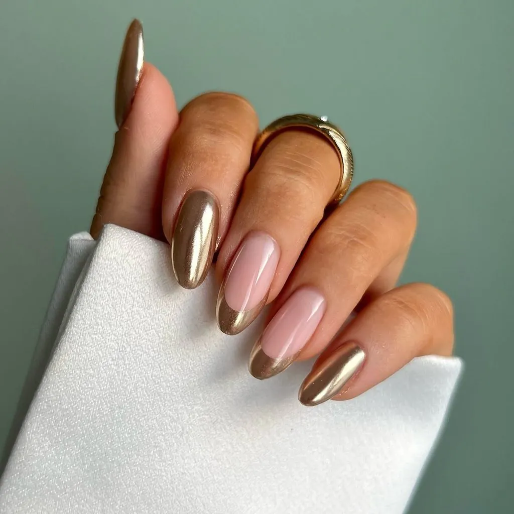 oval almond nails with metallic champagne gold chrome finish and matching french tips