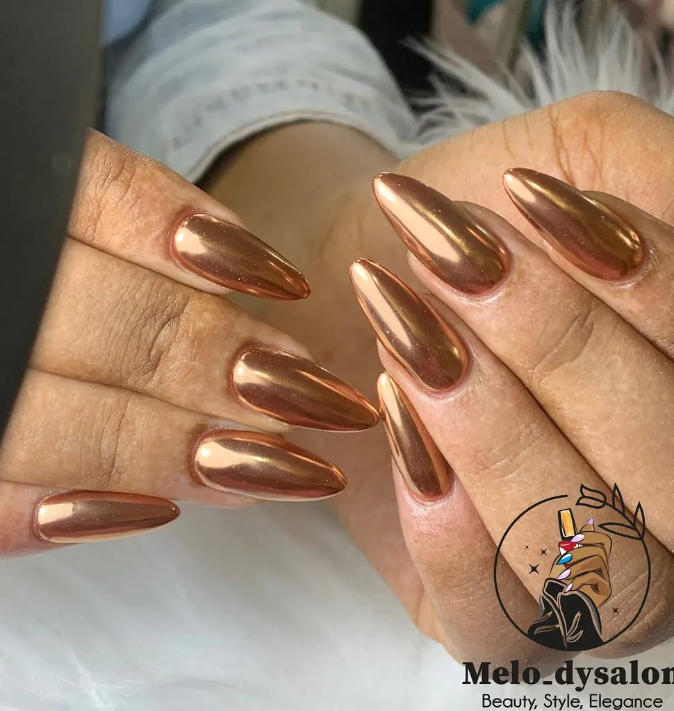glossy metallic copper bronze chrome almond nails on a neutral background