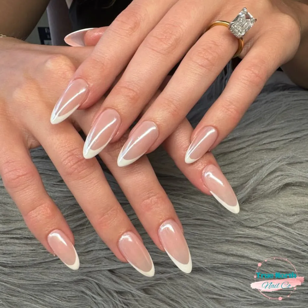 elegant french tip almond nails with pearlescent white chrome finish and diamond ring