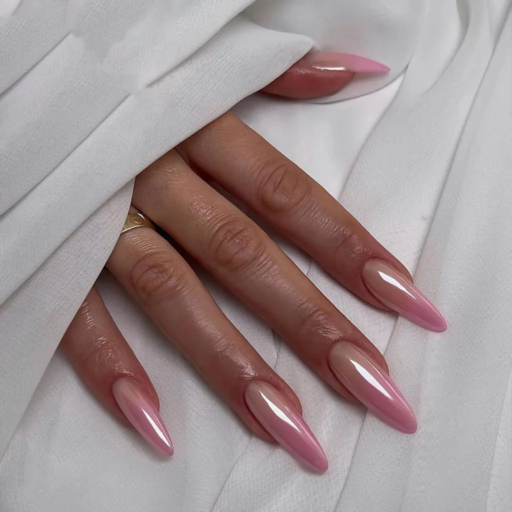 long light pink glazed chrome nails emerging from draped white fabric